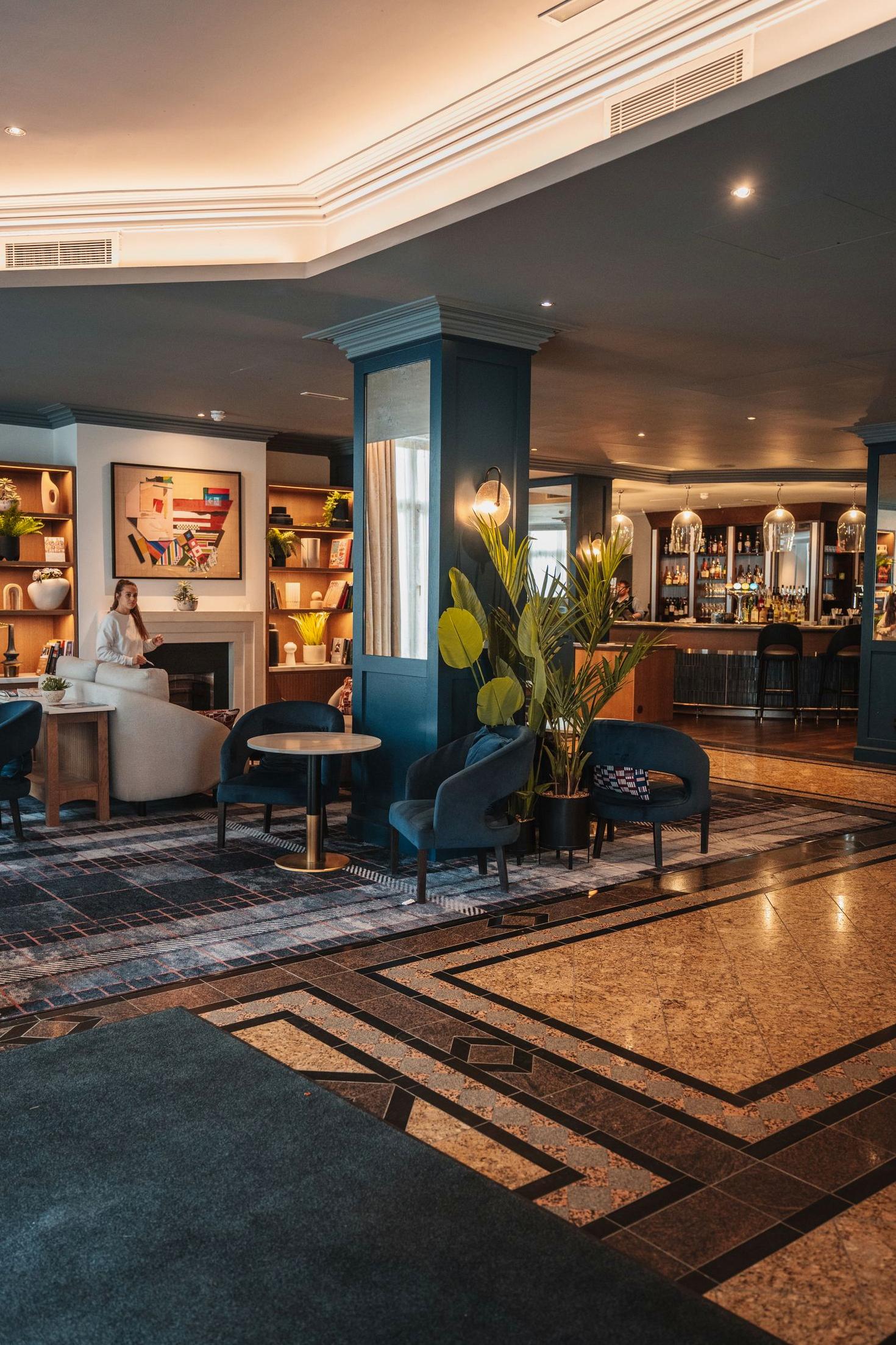 Modern hotel lounge at Blissflash Hotel with warm lighting and contemporary furniture.